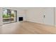 Inviting living room with a fireplace, patio access, and a light wood grain floor at 3141 S Tamarac Dr # 111G, Denver, CO 80231