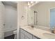 Bright bathroom featuring a double sink vanity with quartz countertops, and a tiled shower-tub combo at 14144 Bunny Hop Ln, Parker, CO 80134