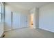 Bedroom with carpet, white walls, white closet, and a view to an ensuite bath at 14144 Bunny Hop Ln, Parker, CO 80134