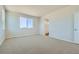 Bright bedroom with neutral carpet, white walls, large window and an ensuite bathroom with a standalone tub at 14144 Bunny Hop Ln, Parker, CO 80134