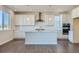 Contemporary kitchen with white cabinets, a center island, and stainless steel range hood at 14144 Bunny Hop Ln, Parker, CO 80134