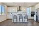 Bright kitchen featuring white cabinets, stainless steel appliances, a center island, and modern pendant lighting at 14144 Bunny Hop Ln, Parker, CO 80134