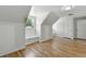 Attic bedroom with hardwood floors, window seats, and dormer windows, providing ample natural light at 3884 S Niagara Way, Denver, CO 80237