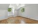 Bright attic space featuring natural light from windows and newly finished hardwood flooring at 3884 S Niagara Way, Denver, CO 80237