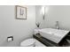 Modern bathroom featuring a stylish sink, granite countertop, and minimalist decor at 3884 S Niagara Way, Denver, CO 80237