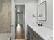 Elegant bathroom with a modern vanity, stylish mirror, and easy access to hallway at 3884 S Niagara Way, Denver, CO 80237