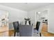 Dining room featuring hardwood floors, adjoined kitchen access and seating for four at 3884 S Niagara Way, Denver, CO 80237