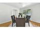 Dining room displaying hardwood floors, natural light and open access to an adjoined room at 3884 S Niagara Way, Denver, CO 80237