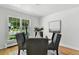 Dining room showcasing hardwood floors, pendant lighting, and natural light from the oversized window at 3884 S Niagara Way, Denver, CO 80237