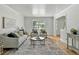 Cozy living room featuring hardwood floors, ample seating, and abundant natural light at 3884 S Niagara Way, Denver, CO 80237