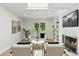 Bright living room featuring a fireplace, hardwood floors, and natural light from a window at 3884 S Niagara Way, Denver, CO 80237
