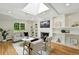 Inviting living room with fireplace, built-in shelves, skylight, and hardwood floors at 3884 S Niagara Way, Denver, CO 80237