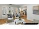 Open-concept living room with hardwood floors, stylish seating, and a view into the kitchen at 3884 S Niagara Way, Denver, CO 80237