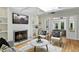 Cozy living room featuring a fireplace, hardwood floors, and comfortable seating at 3884 S Niagara Way, Denver, CO 80237