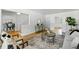 Open living room featuring hardwood floors, neutral decor, and seamless flow to other areas at 3884 S Niagara Way, Denver, CO 80237