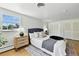 Light filled main bedroom featuring hardwood floors, a king-sized bed and ample natural light at 3884 S Niagara Way, Denver, CO 80237