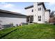 Lush backyard featuring a healthy green lawn, garden beds, and a contemporary home exterior at 1265 Niagara St, Denver, CO 80220
