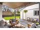 Charming backyard patio with comfortable seating, a covered area, and scenic views of the green lawn at 1265 Niagara St, Denver, CO 80220