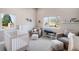 Bright Bedroom featuring a modern crib, neutral-toned seating, and a soothing atmosphere with natural light at 1265 Niagara St, Denver, CO 80220