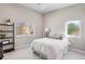 Serene bedroom with minimalist decor, a comfortable bed, and large windows offering pleasant views at 1265 Niagara St, Denver, CO 80220