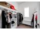 Functional walk-in closet with ample storage space, shelving, and a built-in bench by a bright window at 1265 Niagara St, Denver, CO 80220