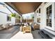 Inviting covered patio with stylish outdoor furniture and hanging floral arrangements, perfect for relaxing at 1265 Niagara St, Denver, CO 80220