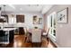 Elegant dining room with a round table, comfortable seating, and natural light from the large windows at 1265 Niagara St, Denver, CO 80220