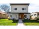 Contemporary two-story home with a minimalist design, well-manicured lawn, and inviting walkway at 1265 Niagara St, Denver, CO 80220