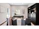 Well-lit home office with a desk, shelving, and comfortable seating, perfect for a productive workspace at 1265 Niagara St, Denver, CO 80220