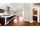 Open-concept kitchen featuring a large island with seating, stainless steel appliances, and access to the dining area at 1265 Niagara St, Denver, CO 80220