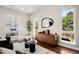Bright living room showcasing modern furniture, a large mirror, and plenty of natural light from multiple windows at 1265 Niagara St, Denver, CO 80220