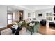Inviting living room with green chairs, stylish decor, and a view into other parts of the house at 1265 Niagara St, Denver, CO 80220