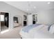 Spacious bedroom with modern decor and a glimpse into the connected bathroom and closet at 1265 Niagara St, Denver, CO 80220