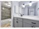 Bathroom featuring marble countertops, tiled shower, wood-look flooring, and modern fixtures at 14602 E 2Nd Ave # 204C, Aurora, CO 80011