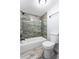Renovated bathroom featuring a modern tub-shower combination and stylish tile work at 14602 E 2Nd Ave # 204C, Aurora, CO 80011