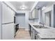 A kitchen view with stainless steel appliances, marble countertops, updated cabinets, and flooring at 14602 E 2Nd Ave # 204C, Aurora, CO 80011