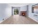 Spacious living area with fireplace, access to balcony, and ample natural light from windows at 14602 E 2Nd Ave # 204C, Aurora, CO 80011