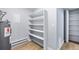 A view of the utility area with ample storage space with shelving and water heater at 14602 E 2Nd Ave # 204C, Aurora, CO 80011