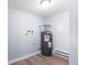 Functional utility area featuring modern water heater and essential hookups, and sleek flooring at 14602 E 2Nd Ave # 204C, Aurora, CO 80011