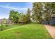 The backyard features a well-maintained lawn, shed and play set at 1411 S Beach Ct, Denver, CO 80219