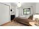 Cozy bedroom with hardwood floors, a large window, and ample closet space at 1411 S Beach Ct, Denver, CO 80219