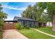 Charming single-story home with a well-maintained lawn and garden beds under the windows at 1411 S Beach Ct, Denver, CO 80219