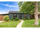 Charming home featuring a well-maintained lawn, lovely landscaping, and a welcoming walkway at 1411 S Beach Ct, Denver, CO 80219