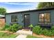 Exterior of home features black trim and window boxes filled with flowers at 1411 S Beach Ct, Denver, CO 80219