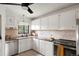 Kitchen features stainless steel appliances, tile countertops, and ample cabinet space at 1411 S Beach Ct, Denver, CO 80219