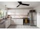 Spacious kitchen boasts stainless steel appliances, granite countertops, and ample cabinet space at 1411 S Beach Ct, Denver, CO 80219