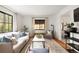 Bright living room features hardwood floors, modern decor, and a large window at 1411 S Beach Ct, Denver, CO 80219