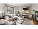 Living room with hardwood floors, neutral decor, and bright natural light at 1411 S Beach Ct, Denver, CO 80219