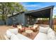 Rear elevation features a cozy outdoor patio and entertainment area at 1411 S Beach Ct, Denver, CO 80219