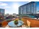 Balcony with brick surround featuring glass table and seating at 930 Acoma St # 420, Denver, CO 80204